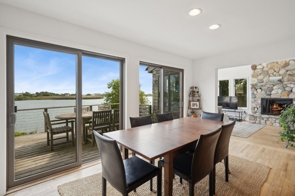 Dining room, Fireplace, Interior, Recessed Lighting, Stone Walls, Water, Wood Texture Flooring