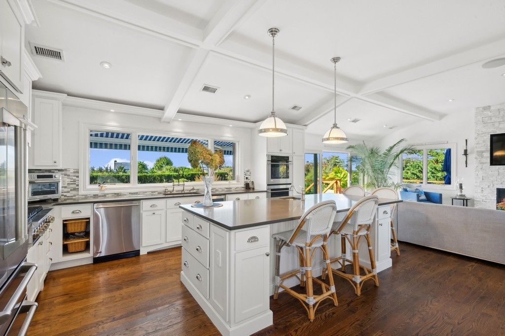 Fireplace, Interior, Kitchen, Living room, Pendant Lights, Recessed Lighting, Stainless Steel Appliances, Stone Walls, Wood Texture Flooring