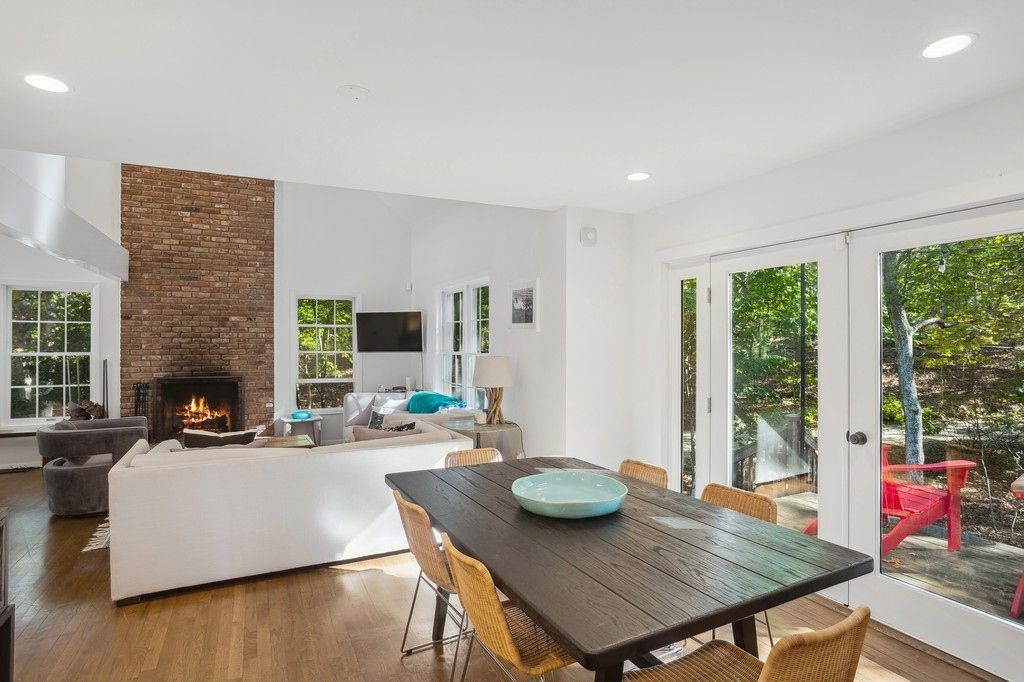 Dining room, Fireplace, Interior, Living room, Recessed Lighting, Stone Walls, Wood Texture Flooring