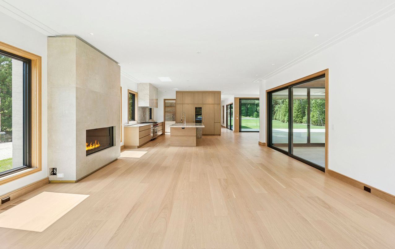 Empty room, Fireplace, Interior, Kitchen, Recessed Lighting, Stainless Steel Appliances, Wood Texture Flooring
