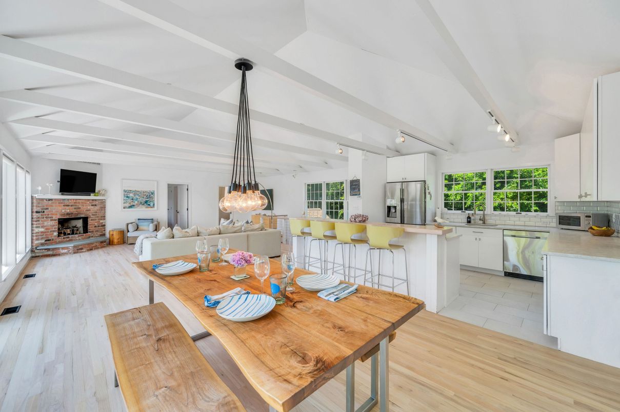 Dining room, Fireplace, Interior, Kitchen, Living room, Pendant Lights, Stainless Steel Appliances, Stone Walls, Wood Texture Flooring