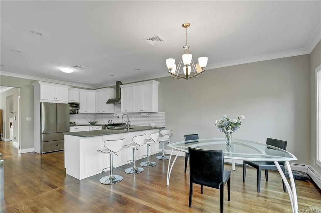 Chandelier, Dining room, Interior, Kitchen, Recessed Lighting, Stainless Steel Appliances, Wood Texture Flooring