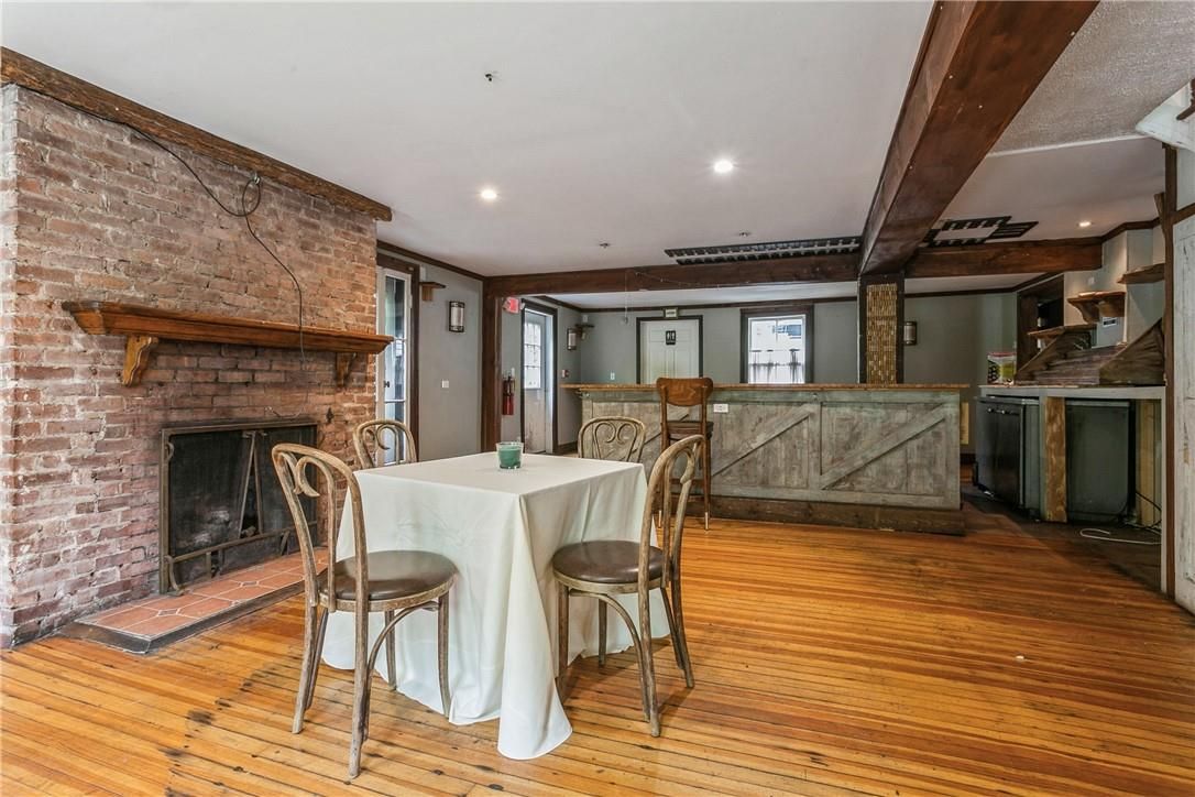 Dining room, Fireplace, Interior, Recessed Lighting, Stone Walls, Wood Texture Flooring