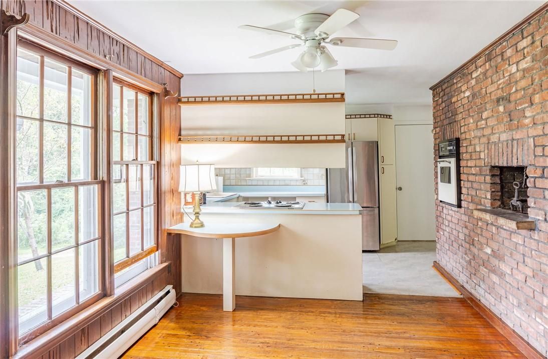 Fireplace, Interior, Kitchen, Stainless Steel Appliances, Stone Walls, Wood Texture Flooring