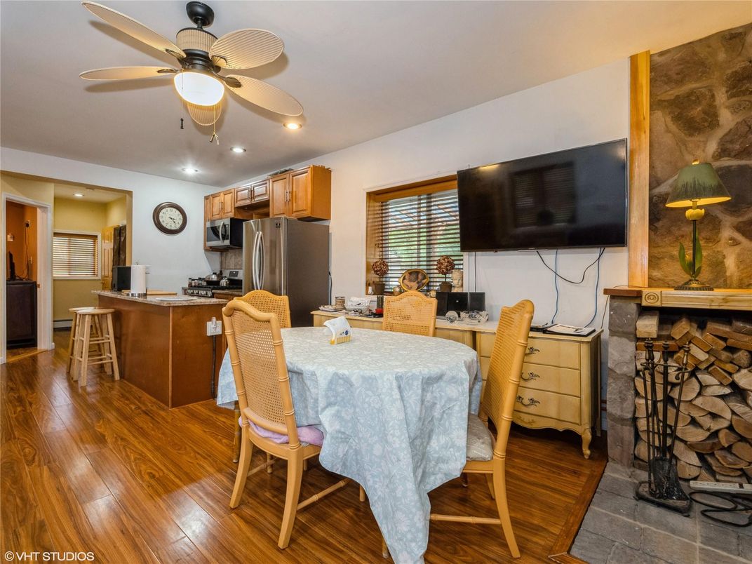 Dining room, Fireplace, Interior, Kitchen, Recessed Lighting, Stainless Steel Appliances, Wood Texture Flooring