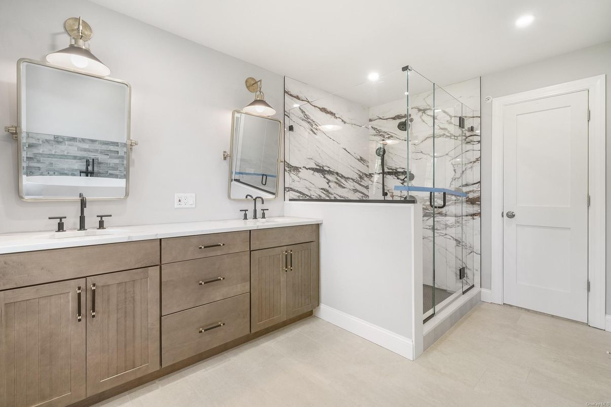 Bathroom, Dual Sink Vanities, Glass Shower, Interior, Marble Walls, Recessed Lighting