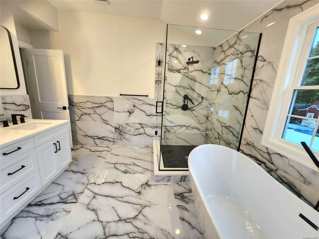 Bathroom, Dual Sink Vanities, Free Standing Baths, Glass Shower, Interior, Marble, Marble Walls, Recessed Lighting