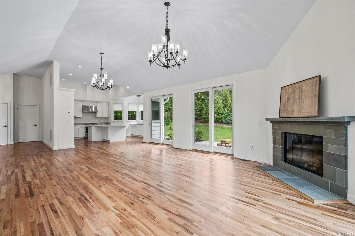 Chandelier, Empty room, Fireplace, Interior, Kitchen, Recessed Lighting, Wood Texture Flooring