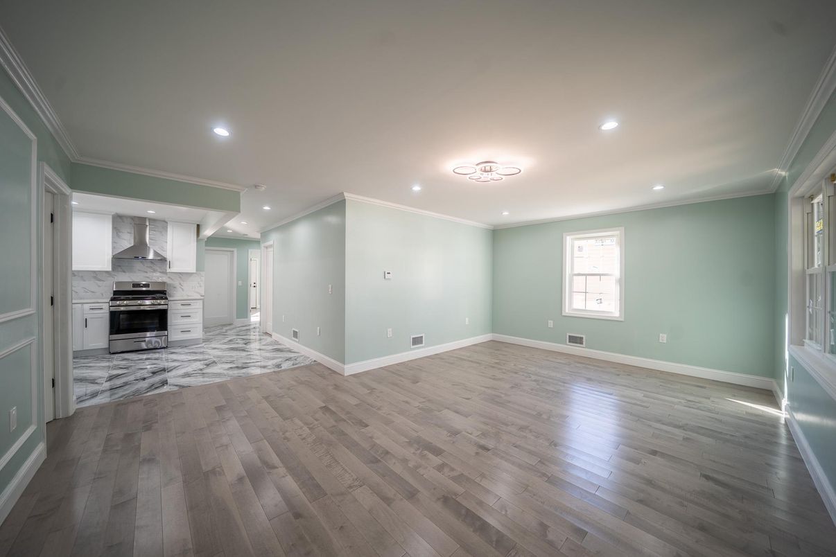 Empty room, Interior, Kitchen, Recessed Lighting, Stainless Steel Appliances, Wood Texture Flooring
