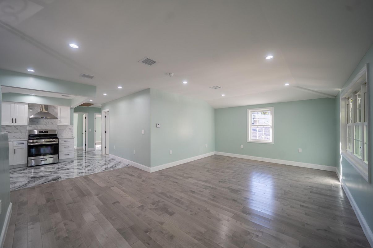 Empty room, Interior, Kitchen, Recessed Lighting, Stainless Steel Appliances, Wood Texture Flooring