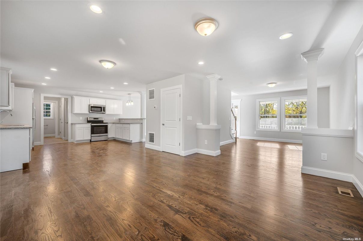 Empty room, Interior, Kitchen, Recessed Lighting, Stainless Steel Appliances, Wood Texture Flooring