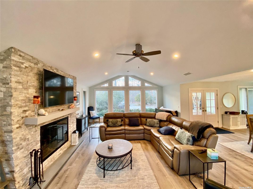 Fireplace, Interior, Living room, Recessed Lighting, Stone Walls, Wood Texture Flooring