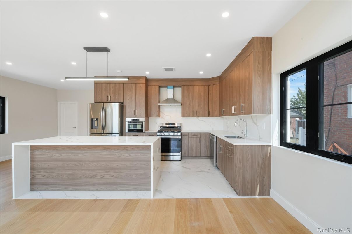 Interior, Kitchen, Marble, Marble Walls, Pendant Lights, Recessed Lighting, Stainless Steel Appliances, Wood Texture Flooring