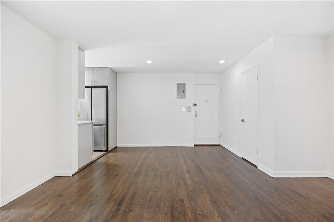 Empty room, Interior, Kitchen, Recessed Lighting, Stainless Steel Appliances, Wood Texture Flooring
