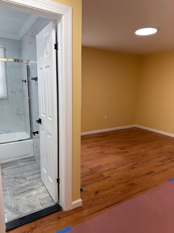 Bathroom, Glass Shower, Interior, Marble Walls, Recessed Lighting, Wood Texture Flooring