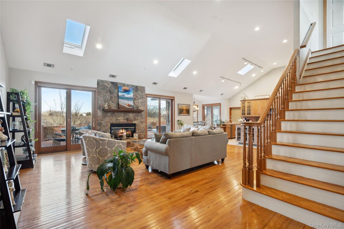 Fireplace, Interior, Living room, Recessed Lighting, Stone Walls, Wood Texture Flooring