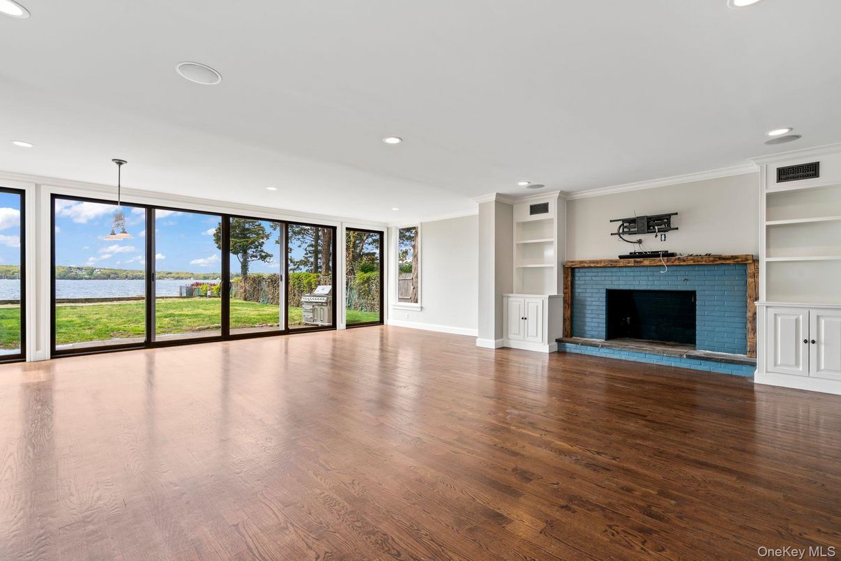Empty room, Fireplace, Interior, Pendant Lights, Recessed Lighting, Water, Wood Texture Flooring