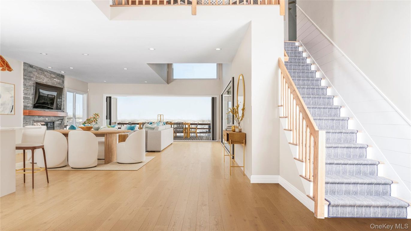 Dining room, Fireplace, Interior, Living room, Recessed Lighting, Stone Walls, Wood Texture Flooring