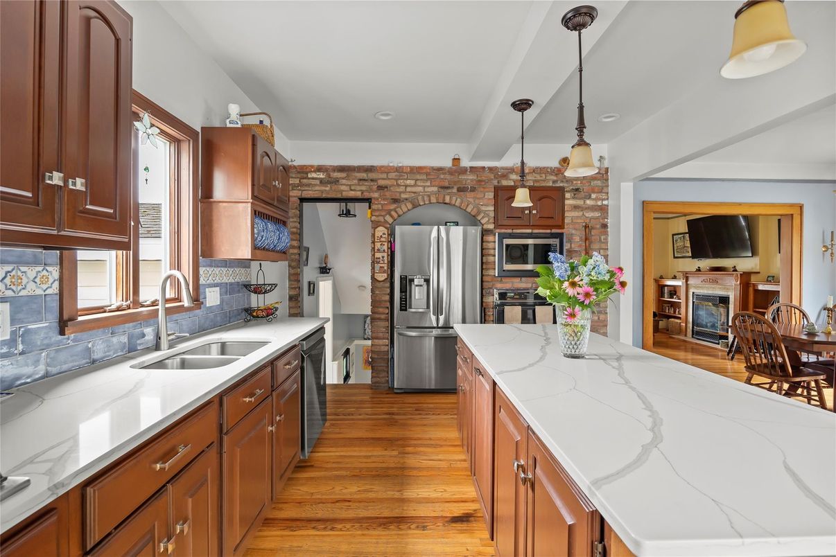 Fireplace, Interior, Kitchen, Pendant Lights, Recessed Lighting, Stainless Steel Appliances, Stone Walls, Wood Texture Flooring