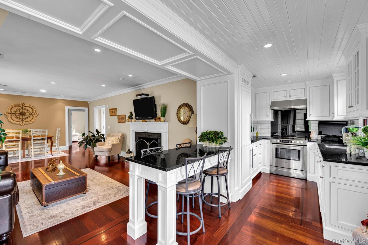 Dining room, Fireplace, Interior, Kitchen, Recessed Lighting, Stainless Steel Appliances, Wood Texture Flooring