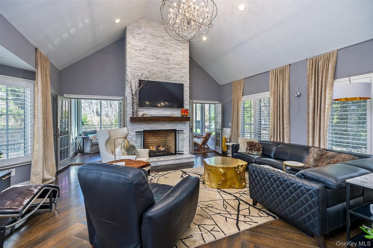 Chandelier, Fireplace, Interior, Living room, Recessed Lighting, Stone Walls, Wood Texture Flooring