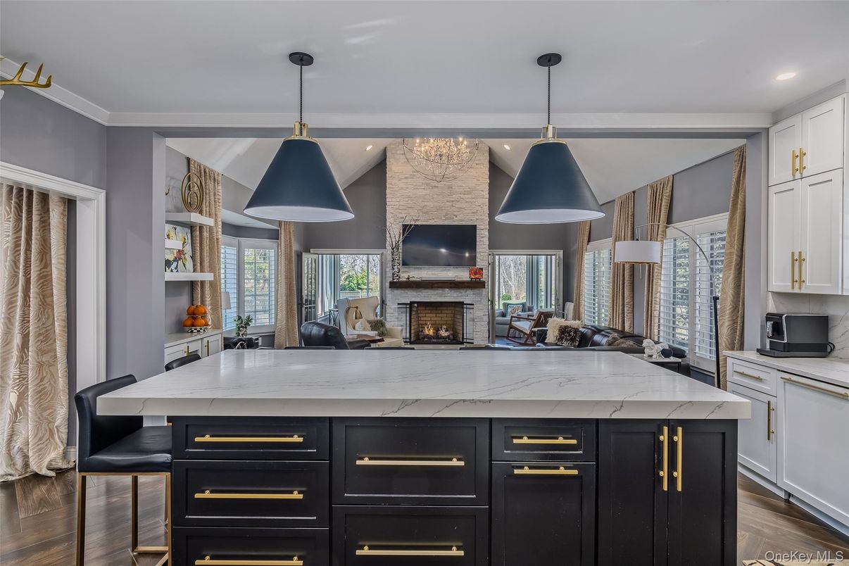Fireplace, Interior, Kitchen, Pendant Lights, Recessed Lighting, Stainless Steel Appliances, Stone Walls, Wood Texture Flooring