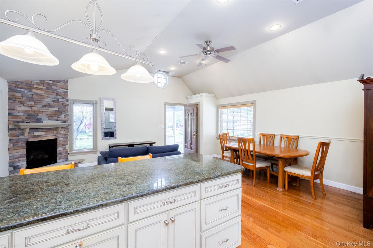 Dining room, Fireplace, Interior, Pendant Lights, Recessed Lighting, Stone Walls, Wood Texture Flooring