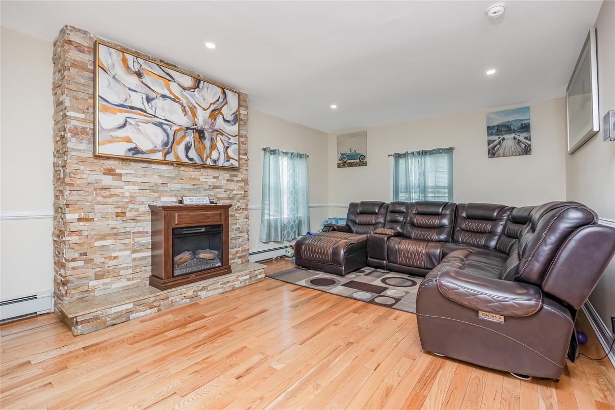 Fireplace, Interior, Living room, Recessed Lighting, Stone Walls, Wood Texture Flooring