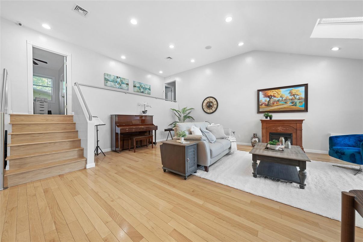 Fireplace, Interior, Living room, Piano, Recessed Lighting, Wood Texture Flooring