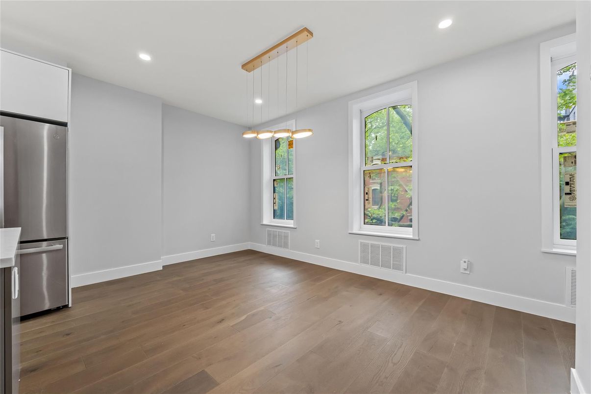 Empty room, Interior, Kitchen, Pendant Lights, Recessed Lighting, Stainless Steel Appliances, Wood Texture Flooring