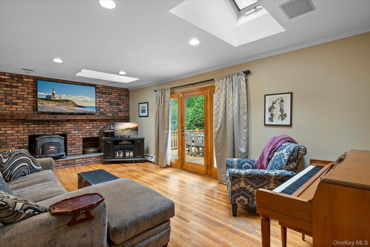 Fireplace, Interior, Living room, Piano, Recessed Lighting, Stone Walls, Wood Texture Flooring