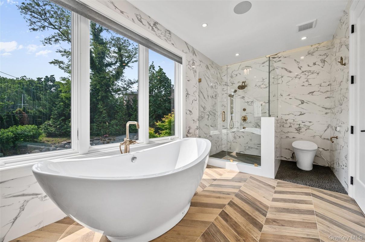 Bathroom, Free Standing Baths, Glass Shower, Interior, Marble Walls, Recessed Lighting, Wood Texture Flooring