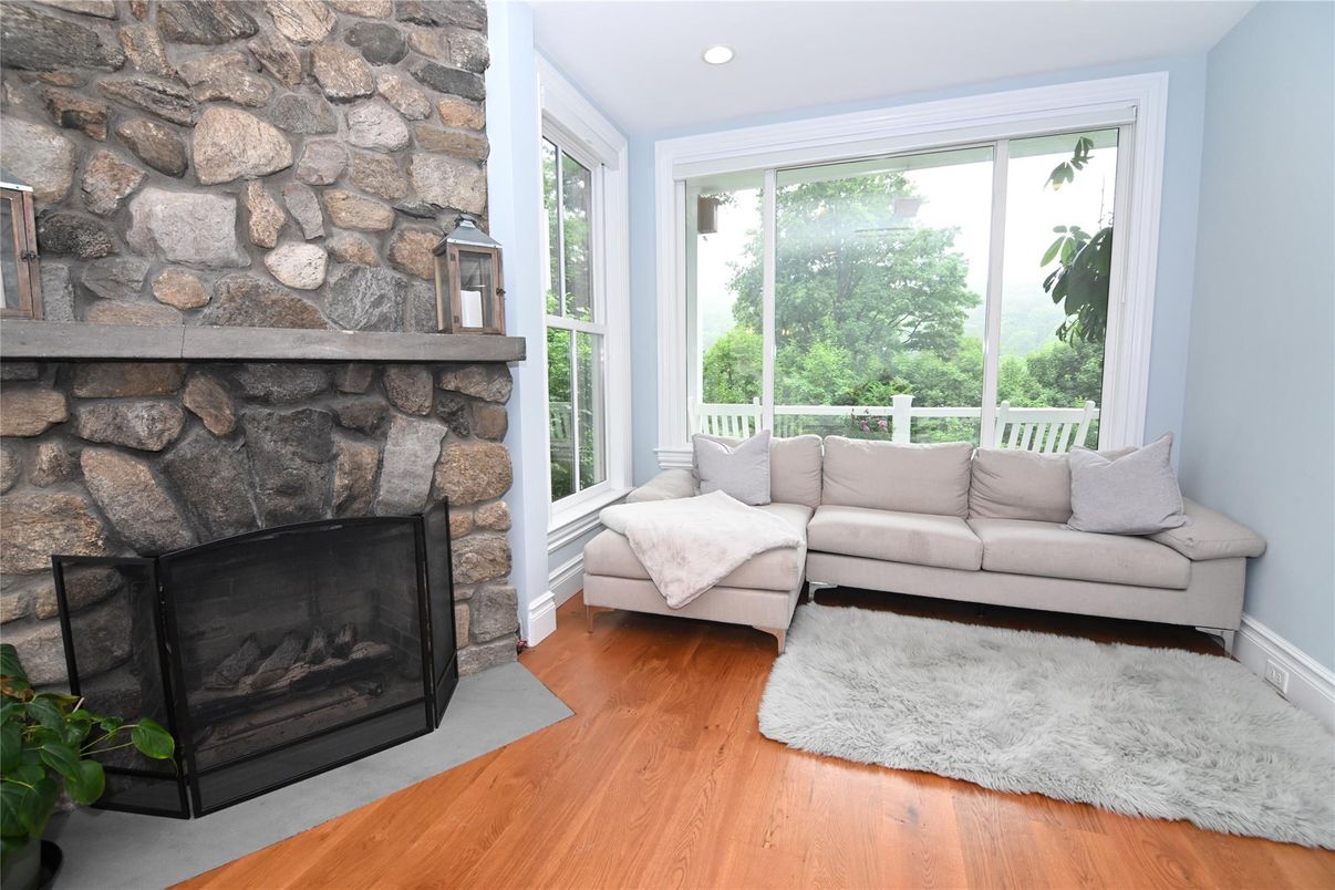 Fireplace, Interior, Living room, Recessed Lighting, Stone Walls, Wood Texture Flooring