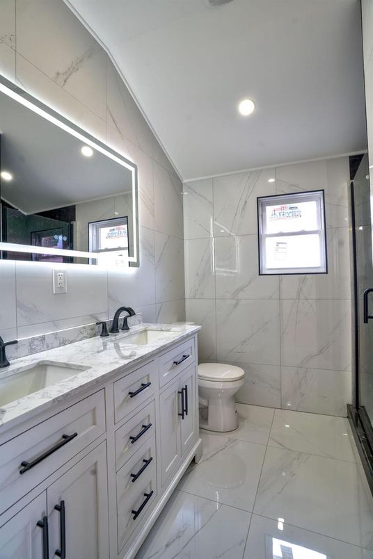 Bathroom, Dual Sink Vanities, Glass Shower, Interior, Marble, Marble Walls, Recessed Lighting