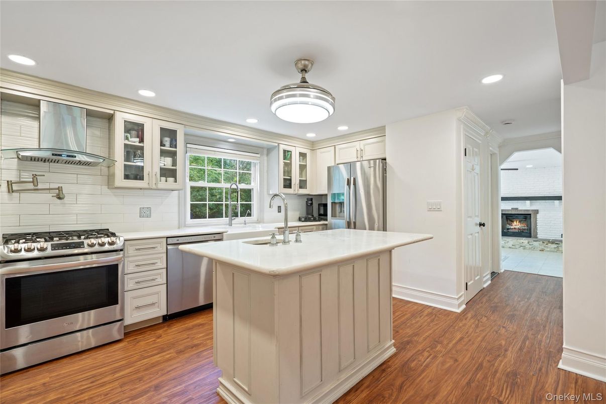 Fireplace, Interior, Kitchen, Recessed Lighting, Stainless Steel Appliances, Wood Texture Flooring