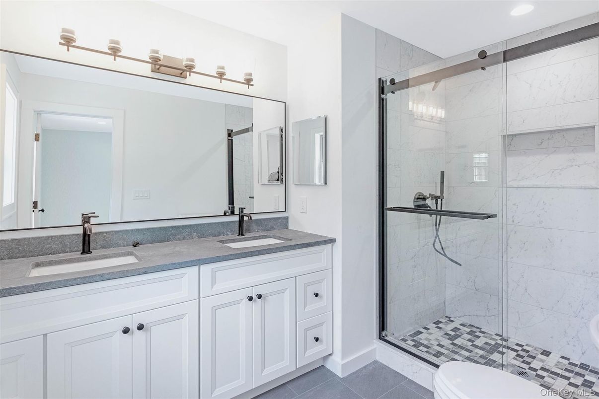 Bathroom, Dual Sink Vanities, Glass Shower, Interior, Marble Walls, Recessed Lighting