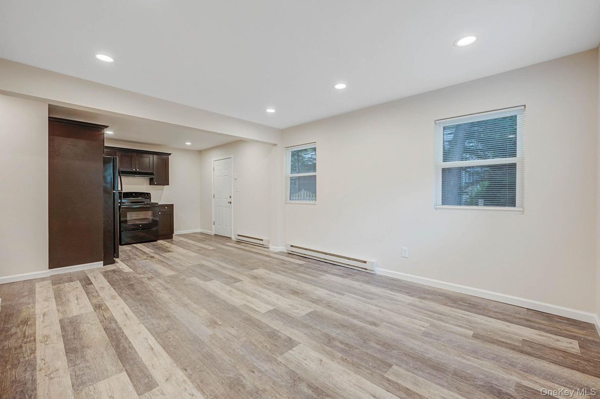 Empty room, Interior, Kitchen, Recessed Lighting, Stainless Steel Appliances, Wood Texture Flooring