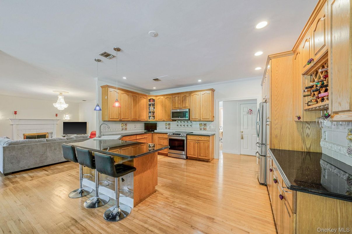 Chandelier, Fireplace, Interior, Kitchen, Living room, Recessed Lighting, Wood Texture Flooring