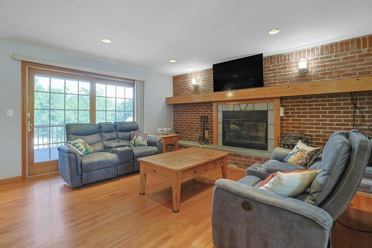 Fireplace, Interior, Living room, Recessed Lighting, Stone Walls, Wood Texture Flooring