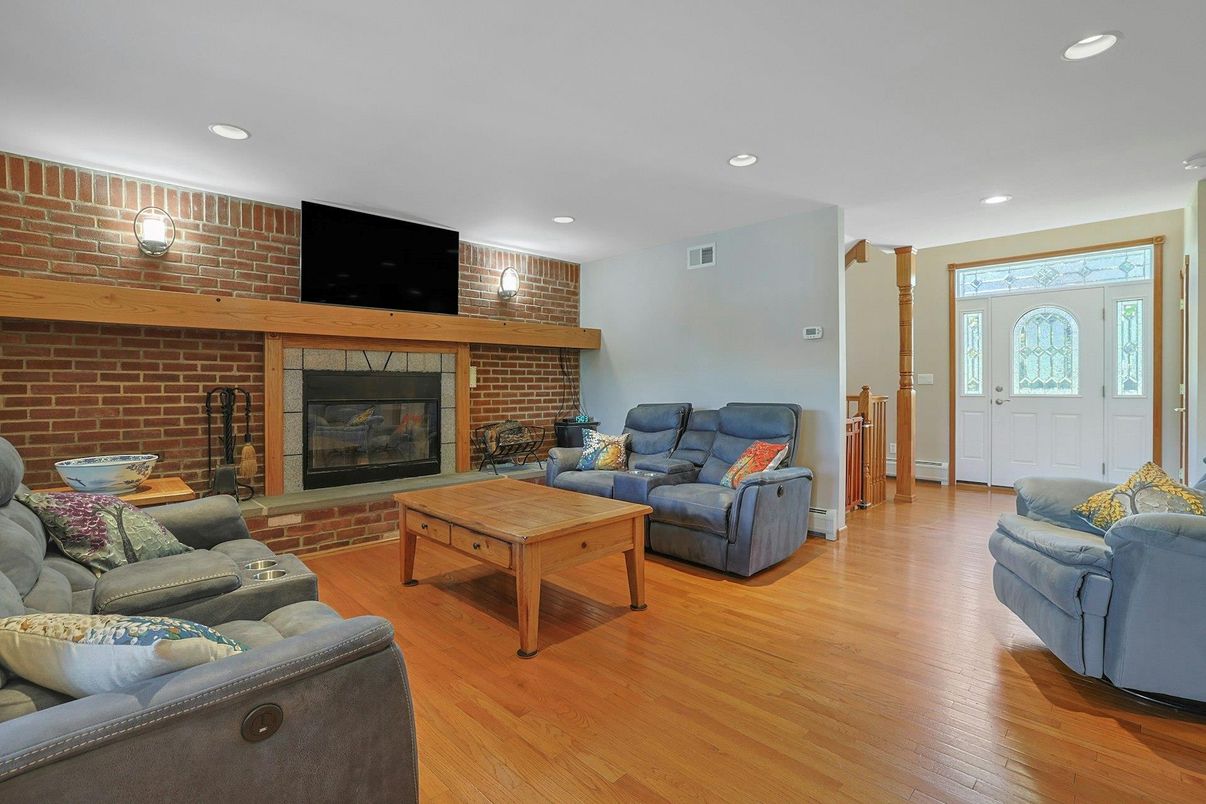Fireplace, Interior, Living room, Recessed Lighting, Stone Walls, Wood Texture Flooring