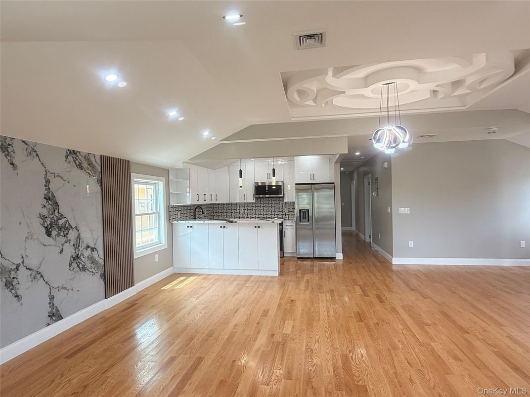 Empty room, Interior, Kitchen, Pendant Lights, Recessed Lighting, Stainless Steel Appliances, Wood Texture Flooring