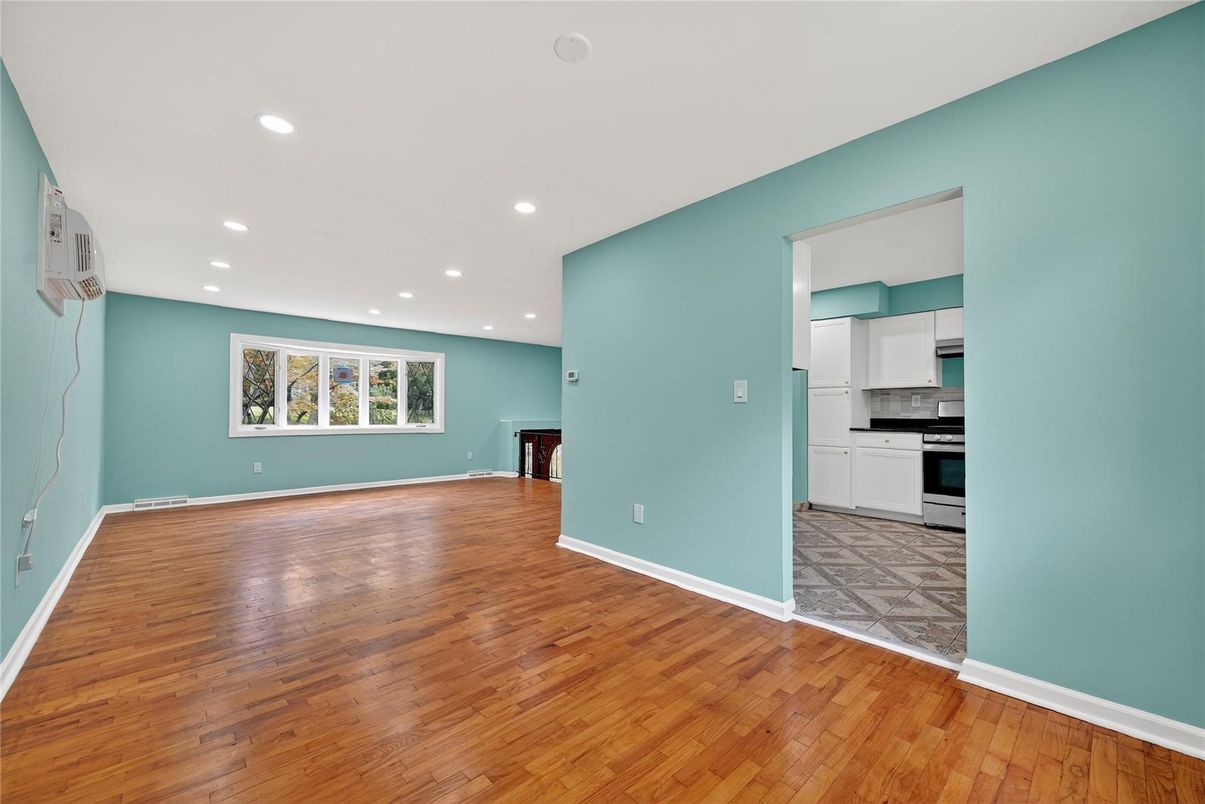 Empty room, Interior, Kitchen, Recessed Lighting, Stainless Steel Appliances, Wood Texture Flooring
