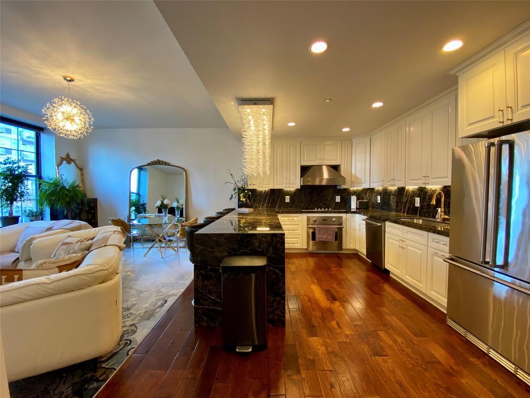 Chandelier, Dining room, Interior, Kitchen, Living room, Pendant Lights, Recessed Lighting, Stainless Steel Appliances, Wood Texture Flooring