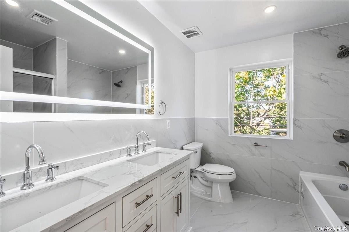 Bathroom, Dual Sink Vanities, Interior, Marble, Marble Walls, Recessed Lighting