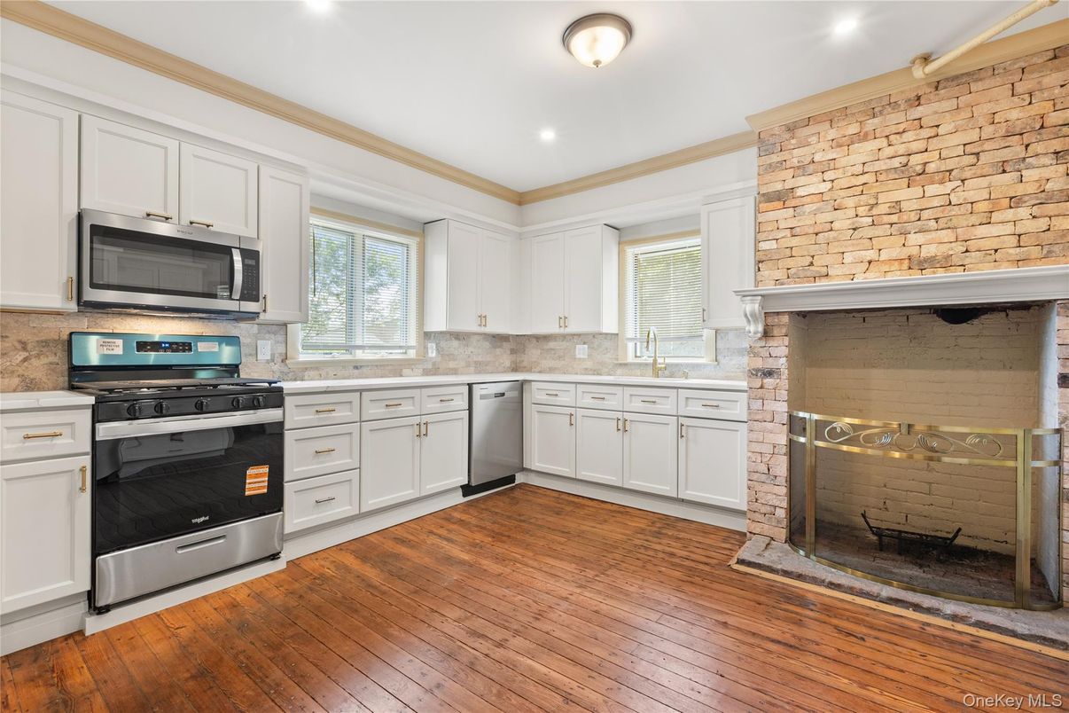 Fireplace, Interior, Kitchen, Recessed Lighting, Stainless Steel Appliances, Stone Walls, Wood Texture Flooring