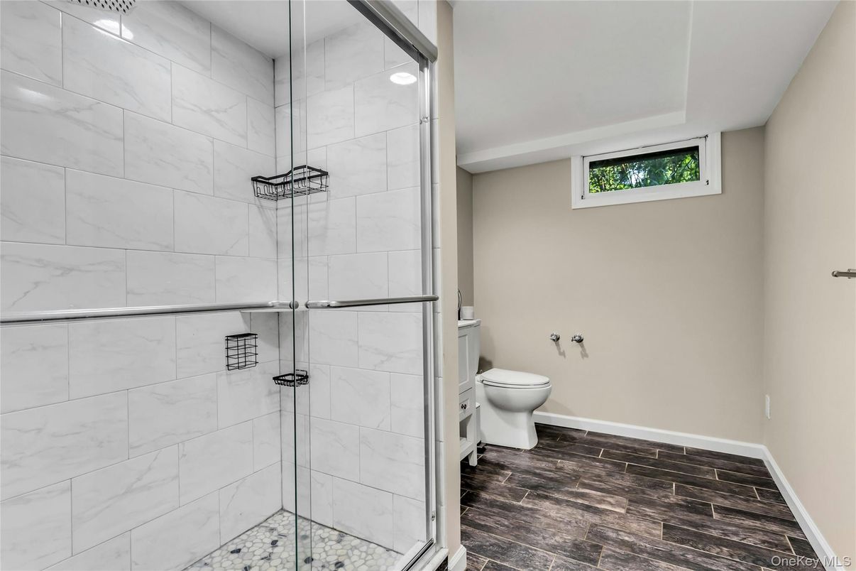 Bathroom, Glass Shower, Interior, Marble Walls, Recessed Lighting, Wood Texture Flooring