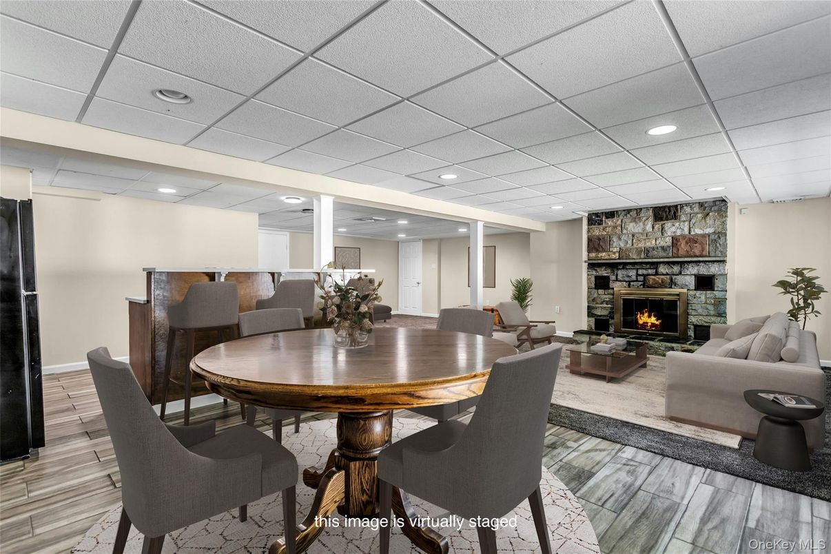 Dining room, Fireplace, Interior, Living room, Recessed Lighting, Stone Walls, Wood Texture Flooring