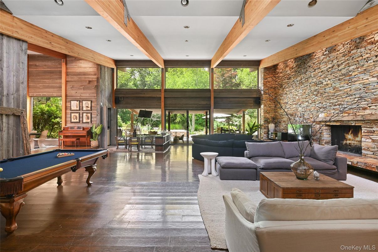 Billiard Table, Fireplace, Game Room, Interior, Living room, Piano, Recessed Lighting, Stone Walls, Wooden Beams, Wood Texture Flooring, Wooden Walls