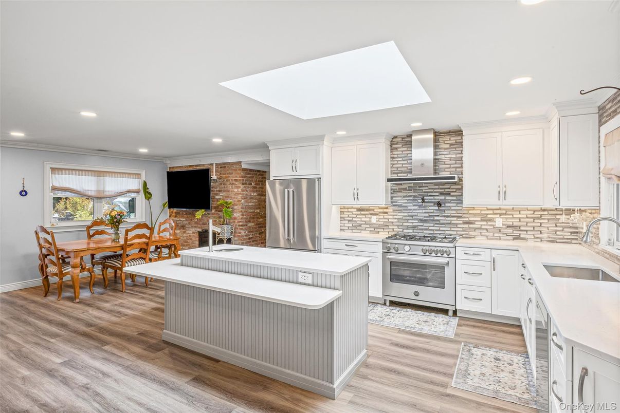 Dining room, Interior, Kitchen, Recessed Lighting, Stainless Steel Appliances, Stone Walls, Wood Texture Flooring