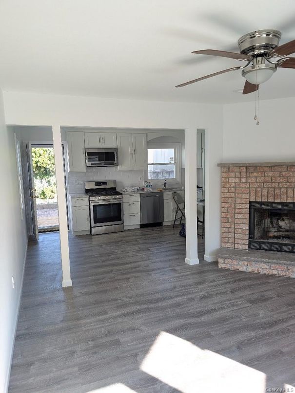 Fireplace, Interior, Kitchen, Stainless Steel Appliances, Wood Texture Flooring